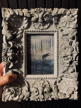 Load image into Gallery viewer, Decorative frame holding a small painting of a bird over water.

